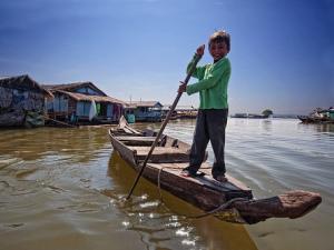 A child in kampong chnang Mekong river tours: rv amalotus upstream cruise trip from saigon to siemreap